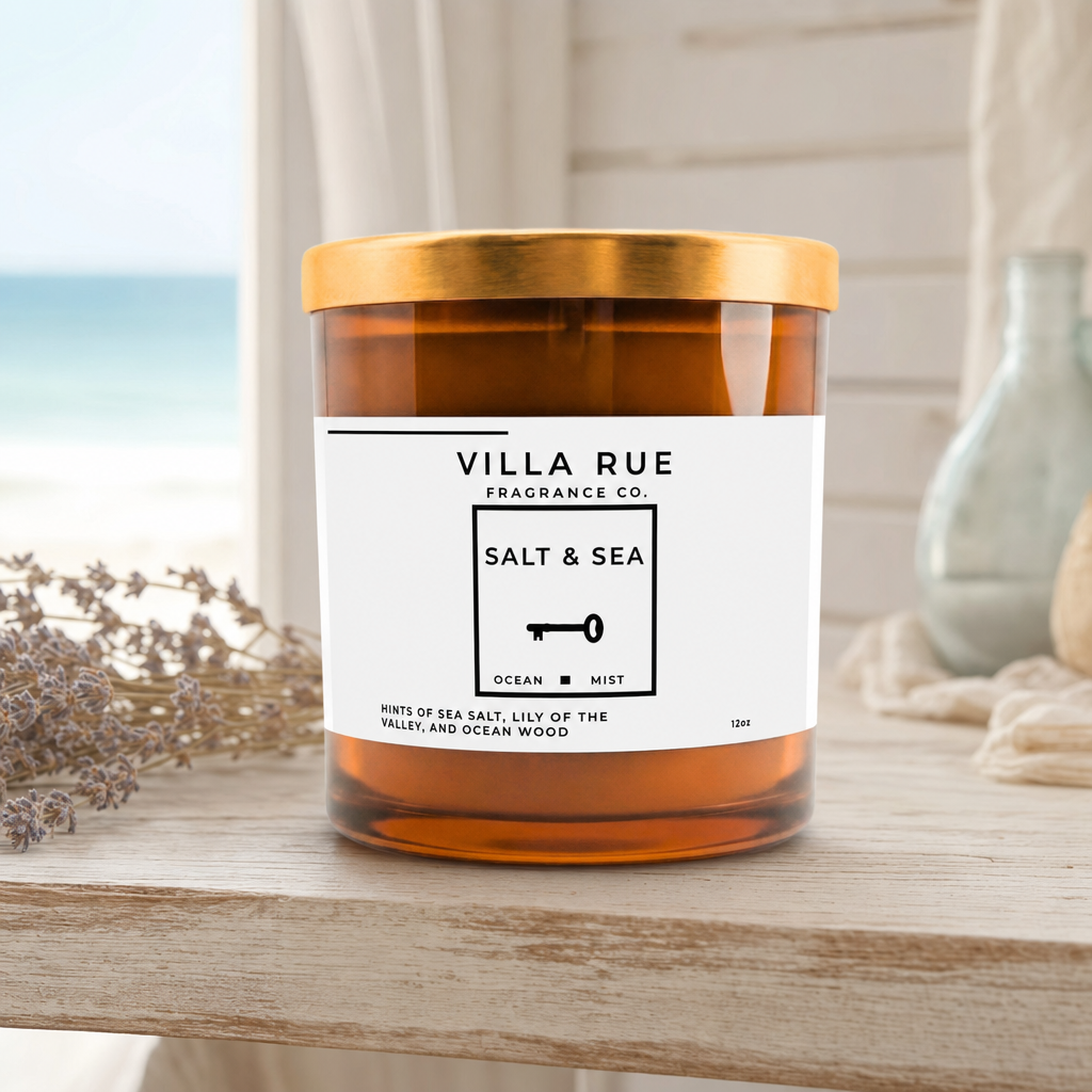Villa Rue Salt & Sea soy candle on a driftwood shelf with soft coastal light